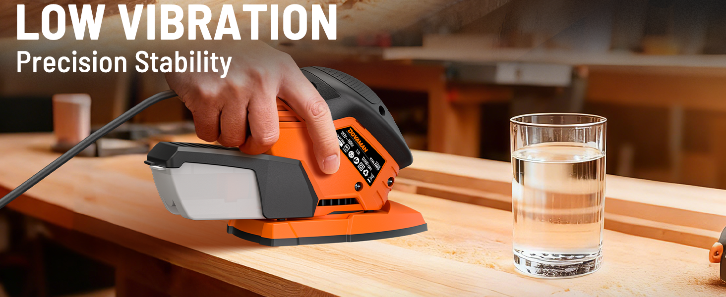 Person using a power sander on a wooden surface with a glass of water nearby, emphasizing low vibration and precision stability.