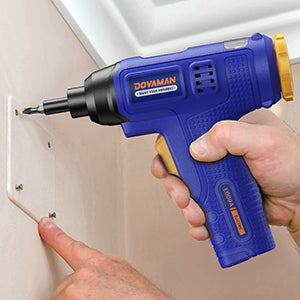 Person using a blue Dovaman screwdriver to install a bracket on a white cabinet.