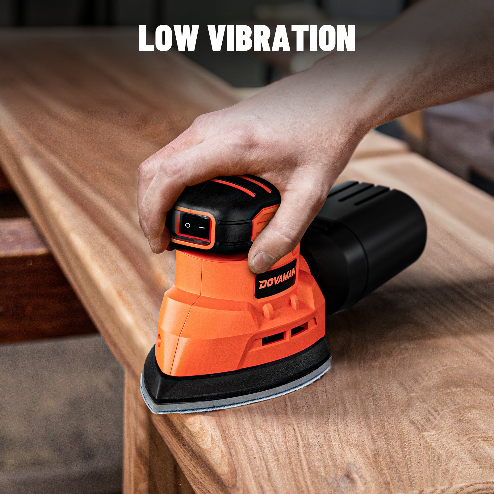 Person using a DOVAMAN sander on a wooden surface with 'Low Vibration' text above.