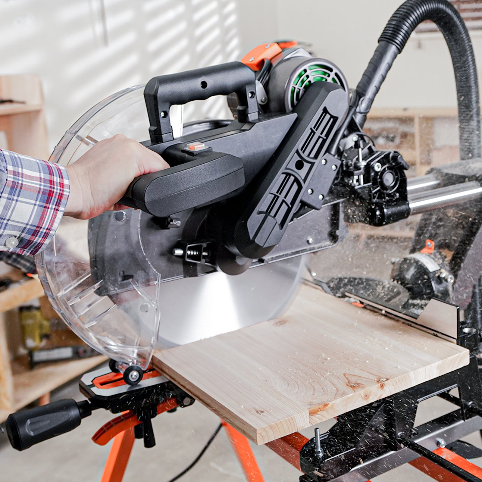 Sliding miter saw in use with a dust collection hose attached for a clean workspace
