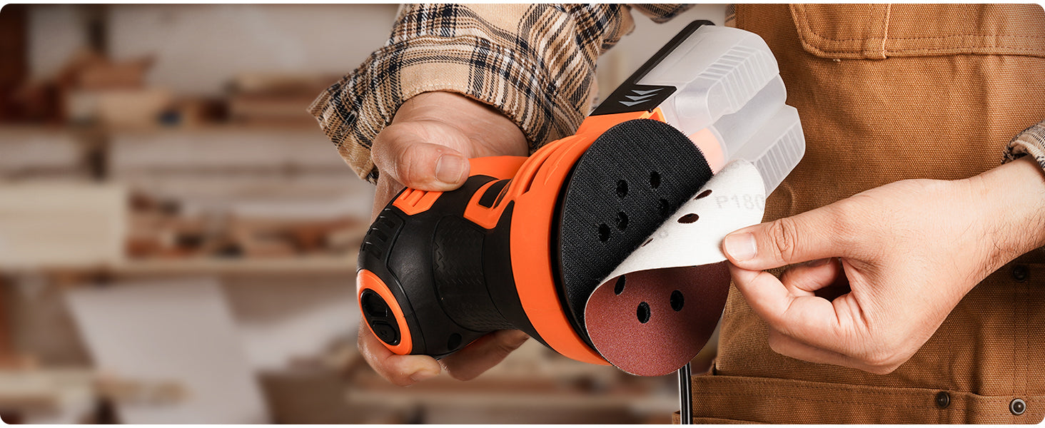 Person holding a power tool with a blurred workshop background