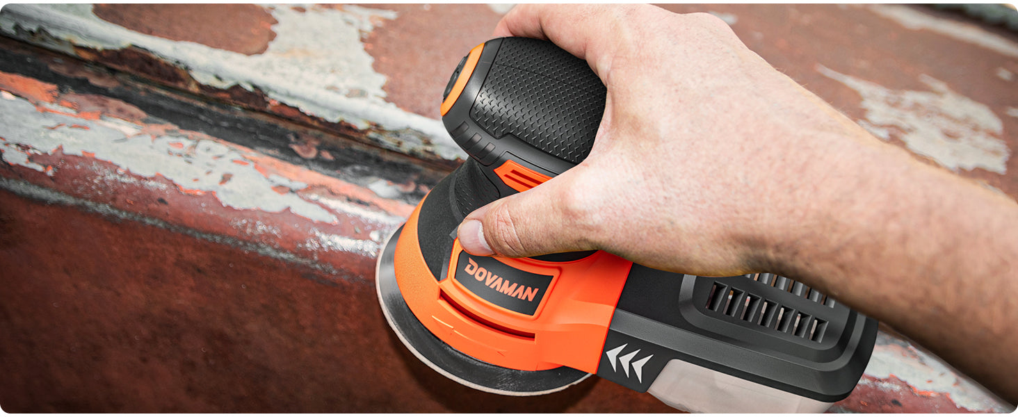 Person using a Dovaman random orbit sander on a surface with visible wear.